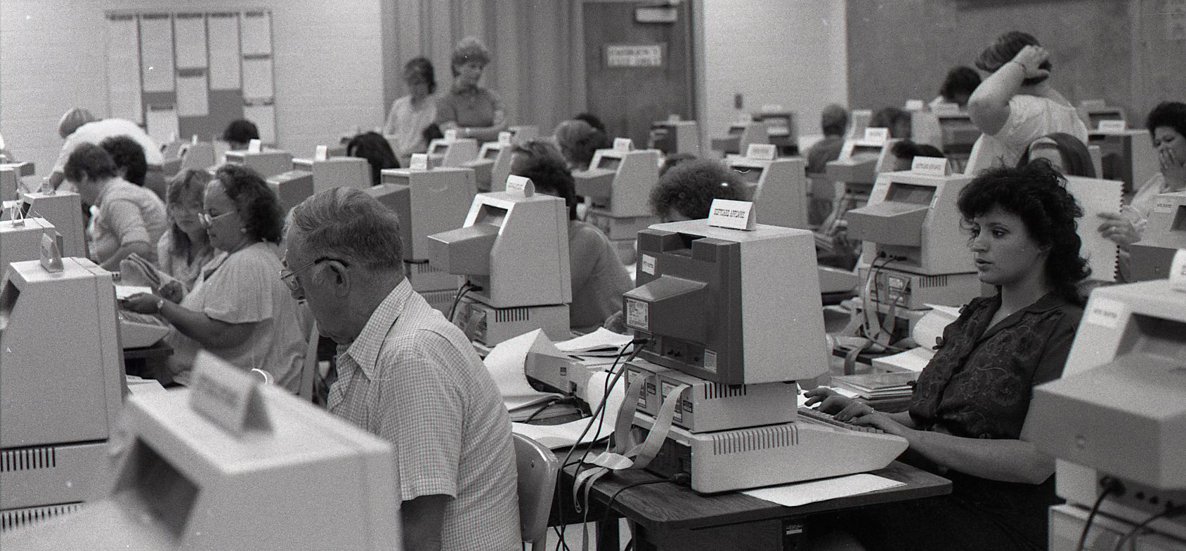 Eighties era photograph of students using computers.